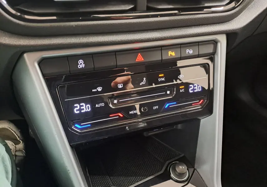 Vue rapprochée du panneau de climatisation digitale du Volkswagen T-Roc 2022, avec affichage de la température à 23°C.