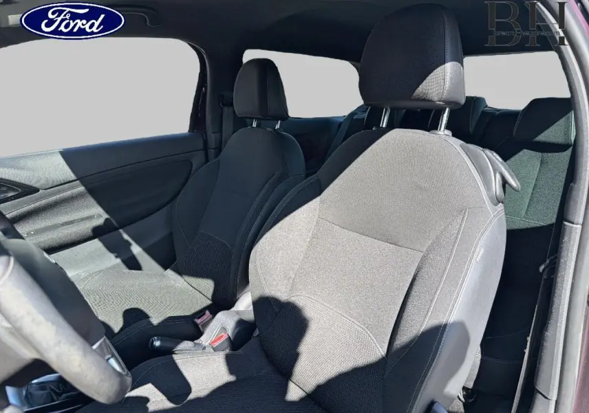 Vue intérieure côté gauche montrant les sièges avant en tissu noir d'une Citroën DS3 rouge Rubi, avec volant partiellement visible.