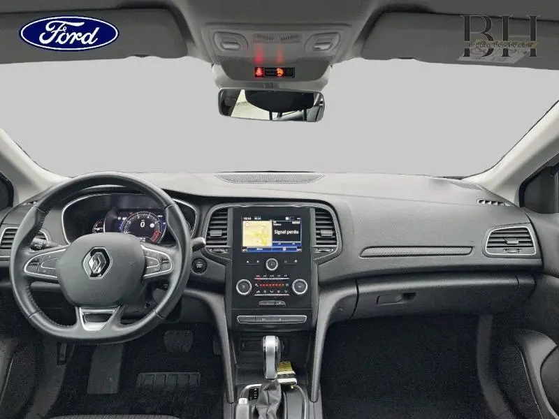 Vue intérieure avant du tableau de bord et volant cuir multifonction d'une Renault Mégane Break gris platine de 2020.