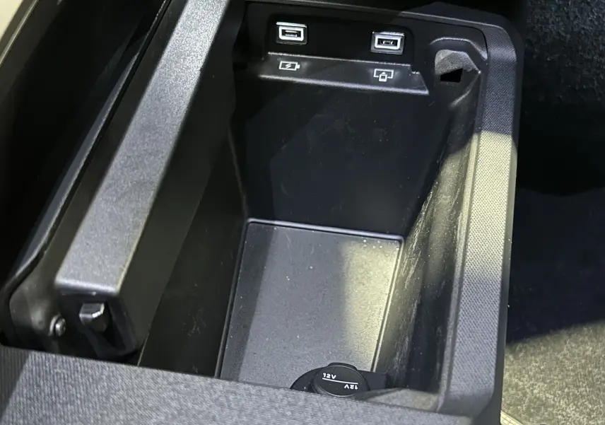 Gros plan sur la console centrale avec ports USB et prise 12V du Peugeot 5008 III Hybrid 145 e-DSC6 GT.