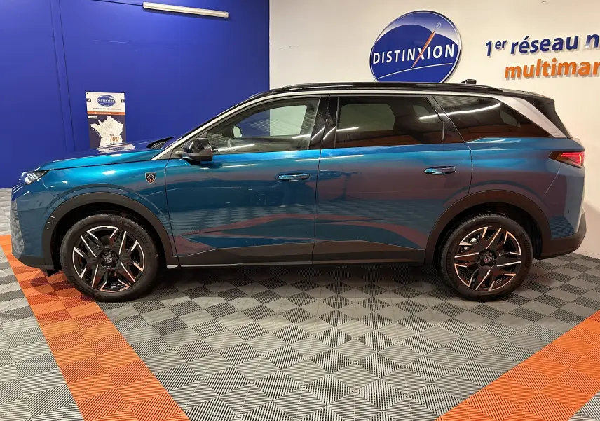 Profil côté gauche du Peugeot 5008 III HYBRID 145 e-DSC6 GT bleu obsession, avec jantes noires et toit noir contrastant.