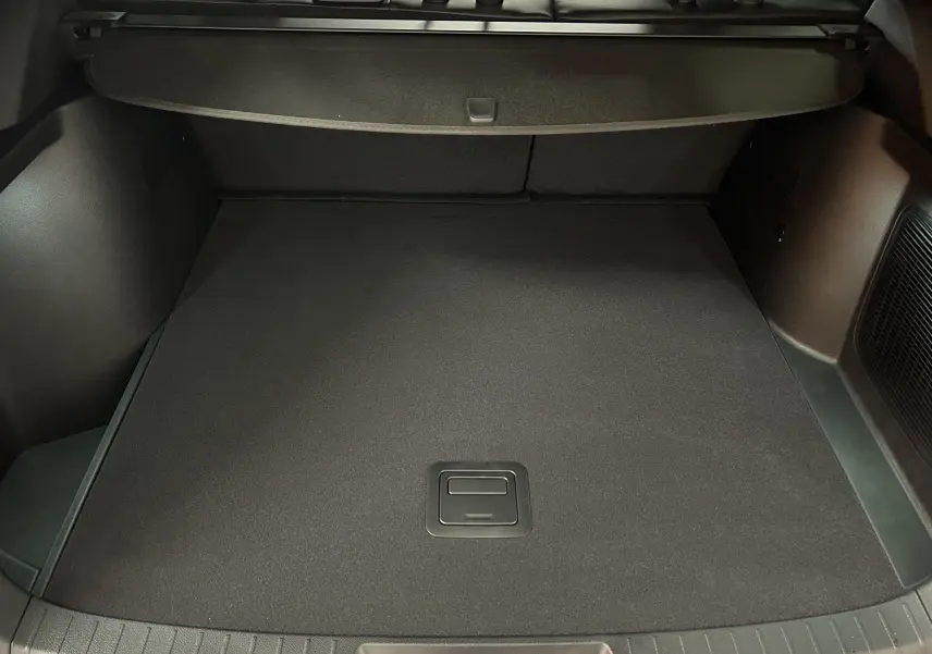 Vue intérieure du coffre spacieux et noir du BYD SEAL U 2025, avec cache-bagages et tapis de sol plat.