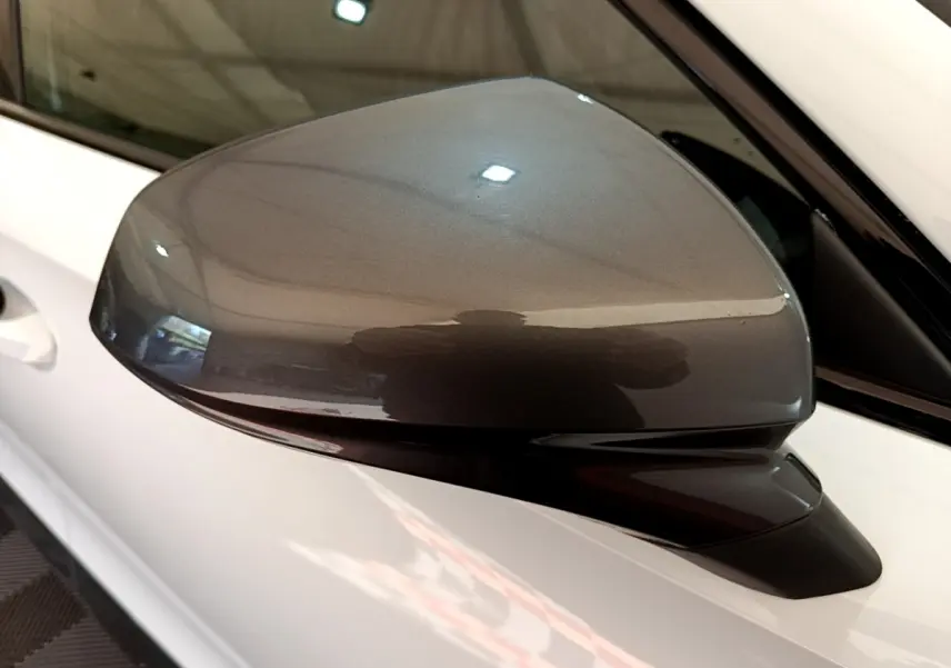 Rétroviseur droit gris métallisé sur CUPRA Formentor 2023 blanc, vue rapprochée en intérieur.