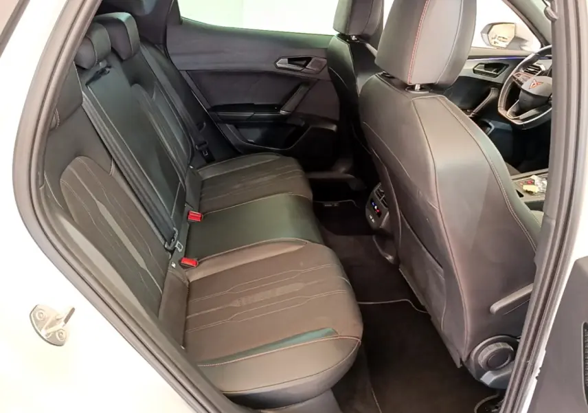 Vue intérieure côté gauche montrant la banquette arrière noire avec surpiqûres rouges du CUPRA Formentor 2023.