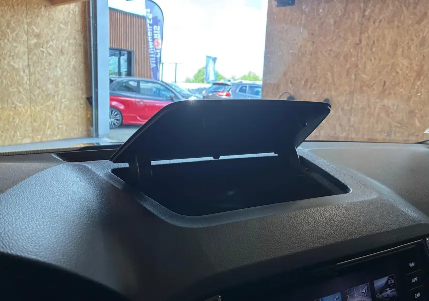Vue intérieure sur le rangement ouvert du tableau de bord gris du Skoda Karoq 2.0 TDI 116 DSG7 Business 2023.