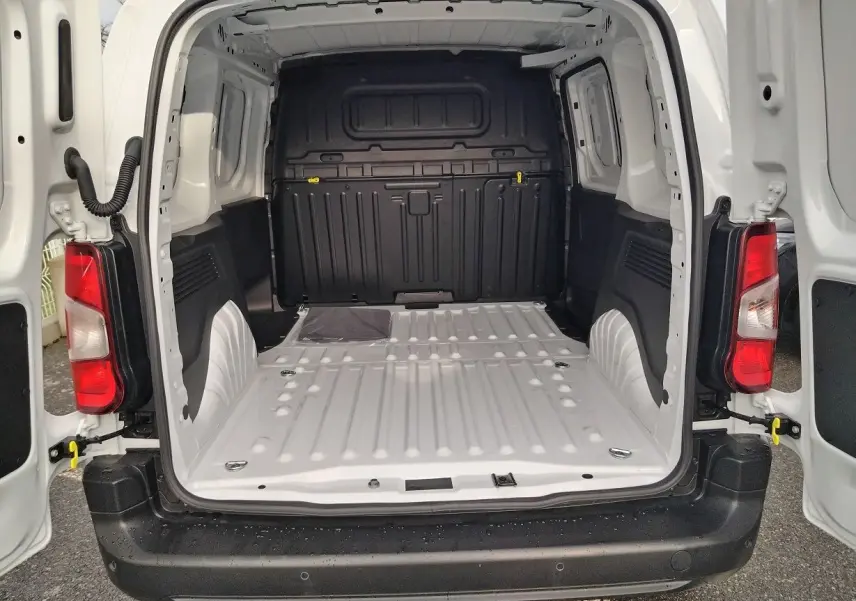 Vue arrière ouverte du Peugeot Partner Fourgon blanc icy 2025, montrant l’espace de chargement vide et les portes battantes.