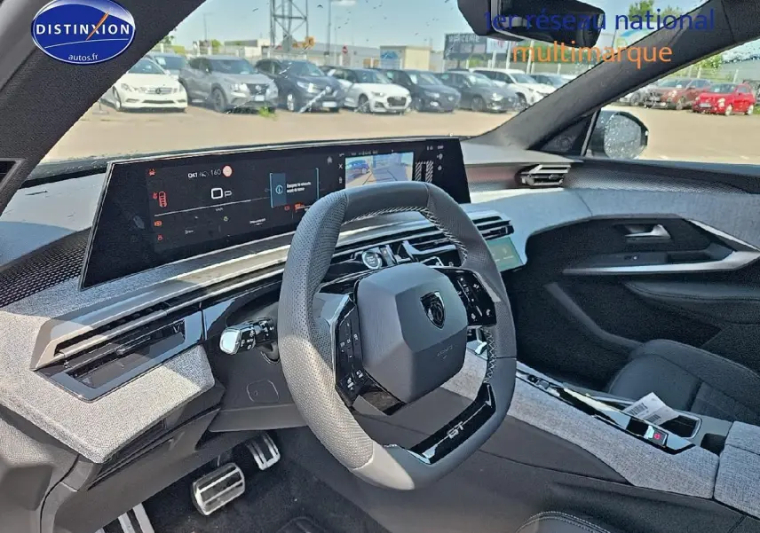Vue intérieure du poste de conduite du Peugeot 3008 noir 2025, volant cuir GT et écran tactile panoramique.
