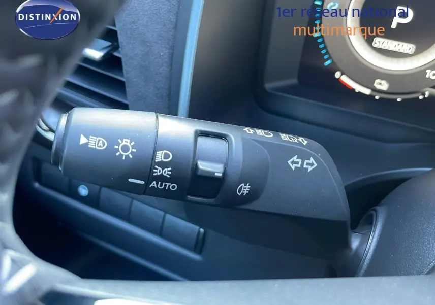 Gros plan sur la commande des phares et clignotants côté gauche du tableau de bord du Nissan Qashqai gris céramique.