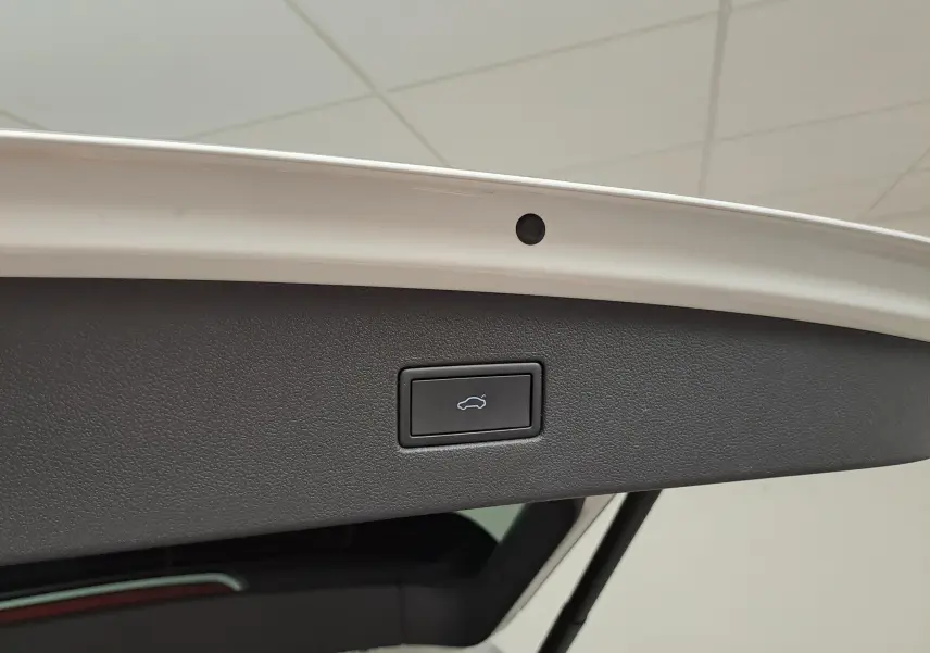 Bouton d'ouverture électrique du coffre sur la partie intérieure du hayon blanc d'un Volkswagen Tiguan Allspace 2023.