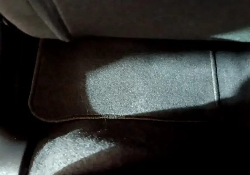 Tapis de sol noir sous le siège avant dans l'habitacle d'une Citroën C3 beige 2022 PureTech Feel Pack