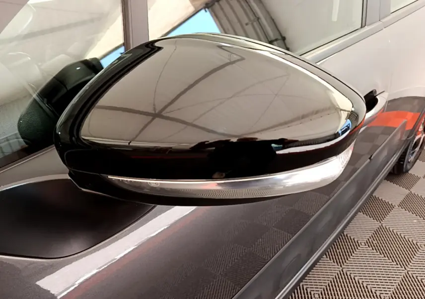 Rétroviseur côté droit noir brillant avec clignotant intégré sur Citroën C3 gris foncé vue rapprochée.