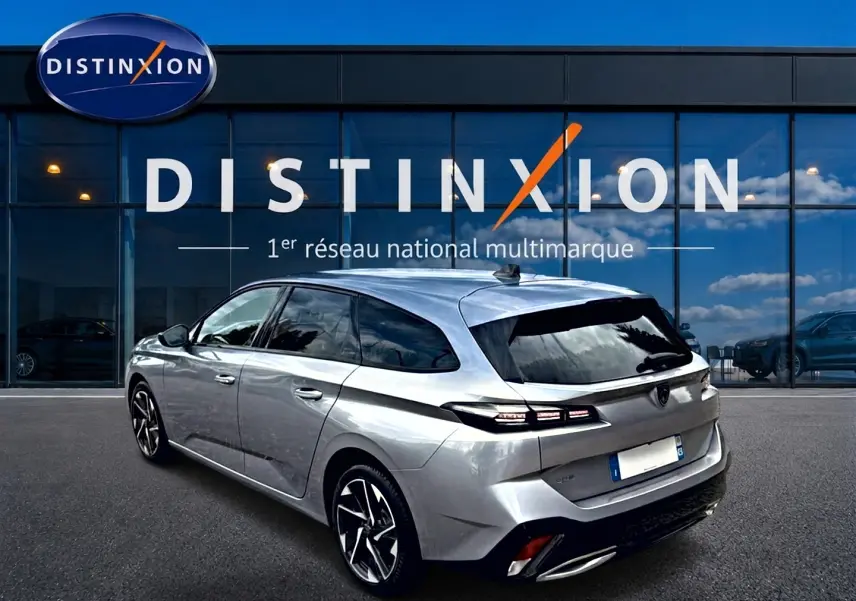 Peugeot 308 SW gris en 3/4 arrière droit, avec vitres surteintées et jantes alliage distinctives.