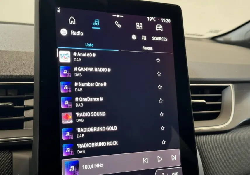 Écran tactile central du tableau de bord du Renault Captur blanc esprit Alpine E-Tech, affichant les stations radio DAB.