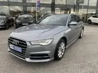 Audi A6 Avant 2.0 TDI S-Line gris métal vue 3/4 avant droit, avec calandre distinctive et jantes alliage 2018.