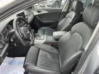 Vue intérieure de l'Audi A6 Avant 2.0 TDI 190 CV S-Line 2018, côté conducteur, sièges cuir noirs et tableau de bord moderne.
