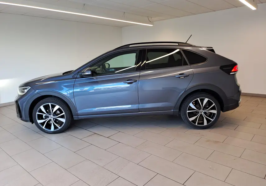 Vue de profil côté gauche du Volkswagen Taigo 1.0 TSI R-Line 2025 en gris cendré métallisé avec jantes alliage 18 pouces.