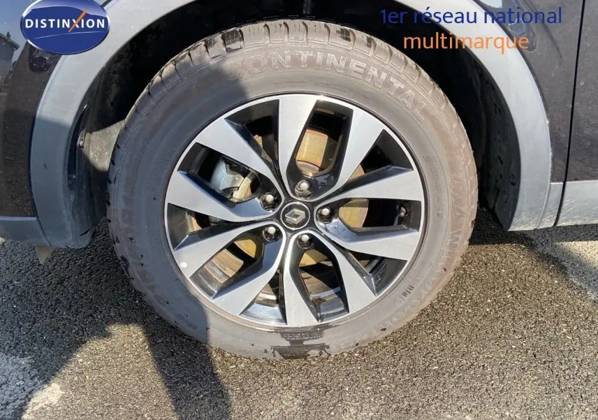 Gros plan sur la roue avant droite noire métal d’un Renault Arkana 1.6 E-TECH Hybrid avec jante alliage bicolore.