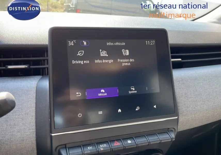 Écran tactile central du tableau de bord de la Renault Clio blanche, affichant les infos véhicule en intérieur.