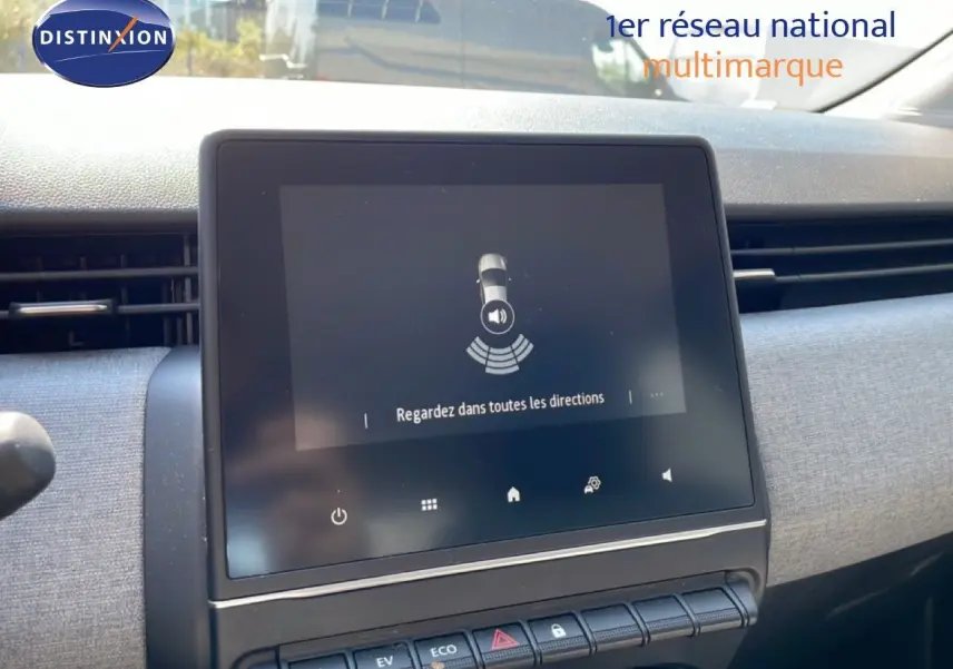 Écran tactile central de la Renault Clio blanche 2025 affichant une alerte de surveillance des angles morts.