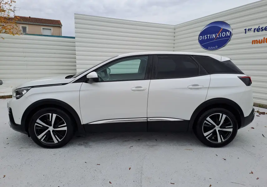 Profil côté gauche d’un Peugeot 3008 blanc de 2018 avec jantes alliage bicolores et toit noir contrasté.