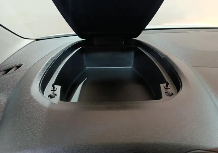 Vue rapprochée du compartiment de rangement ouvert sur le tableau de bord noir du Citroën Berlingo blanc 2021.