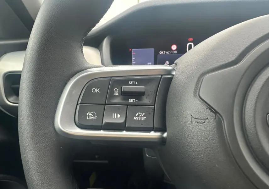 Gros plan sur la partie gauche du volant cuir du Jeep Avenger 2025, avec commandes de régulateur et limiteur de vitesse.