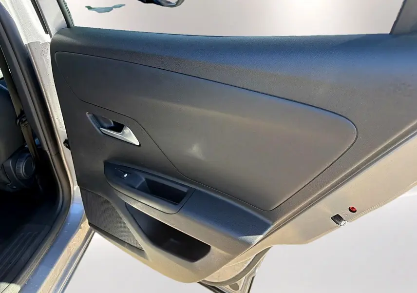 Vue rapprochée de la porte arrière gauche grise de l’Opel Mokka Electric 156 gs avec poignée et commande de vitre.