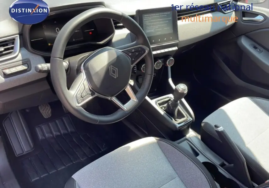 Vue intérieure de la Renault Clio V BluedCi 100ch Evolution 2025, montrant le volant cuir, la boîte manuelle et l’écran tactile central.