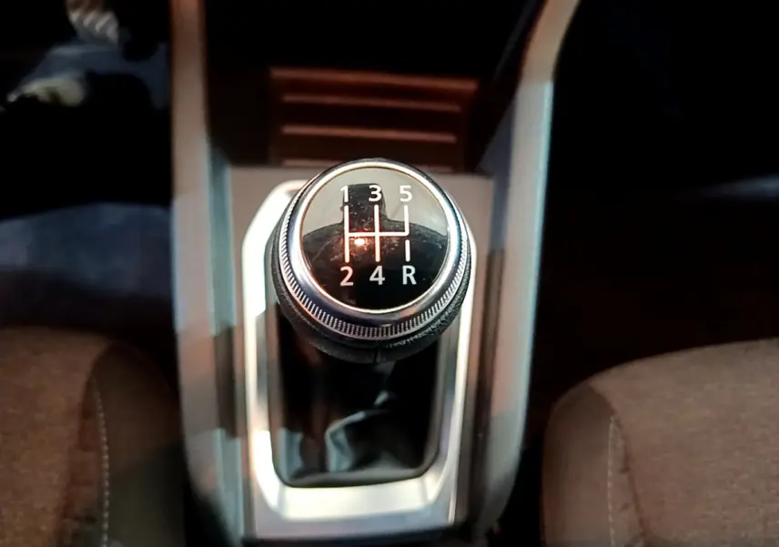 Le levier de vitesses manuel de la Renault Clio Business blanc, vu de dessus entre les sièges avant.