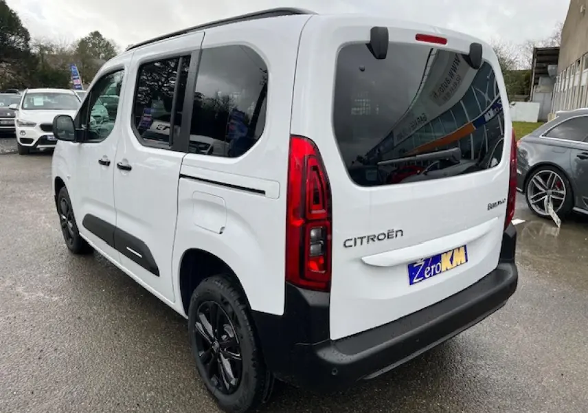 Vue 3/4 arrière droite d'un Citroën Berlingo Multispace blanc 2025 avec vitres teintées et jantes noires.