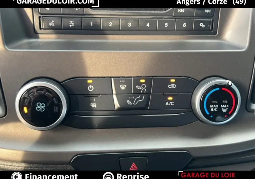 Détail du tableau de bord du Ford Transit Custom blanc 2023 montrant les commandes de climatisation et ventilation.