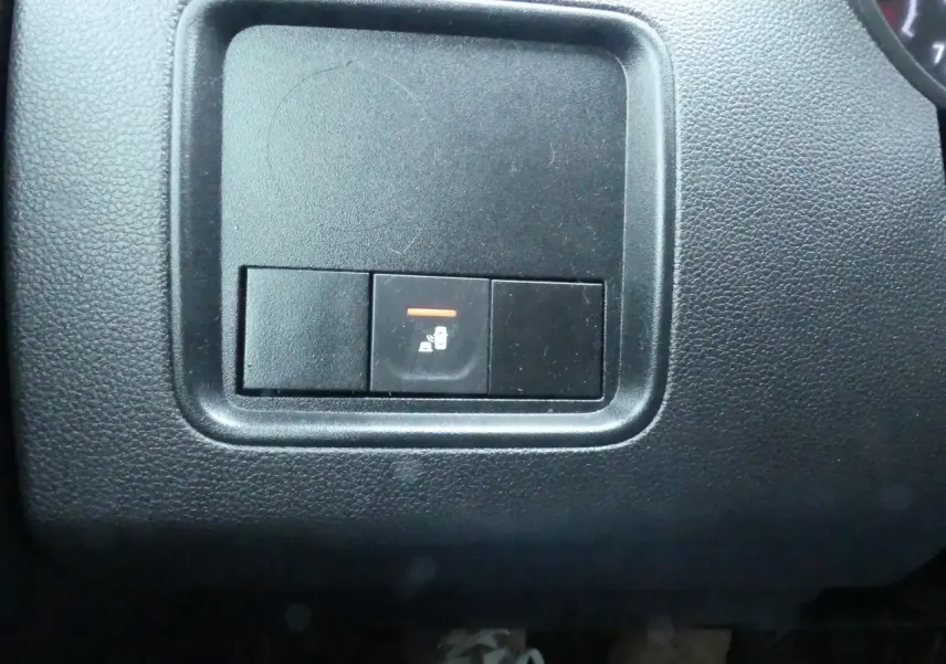 Gros plan sur le bouton de verrouillage centralisé dans l'habitacle noir du Dacia Duster 2023 version Extreme.