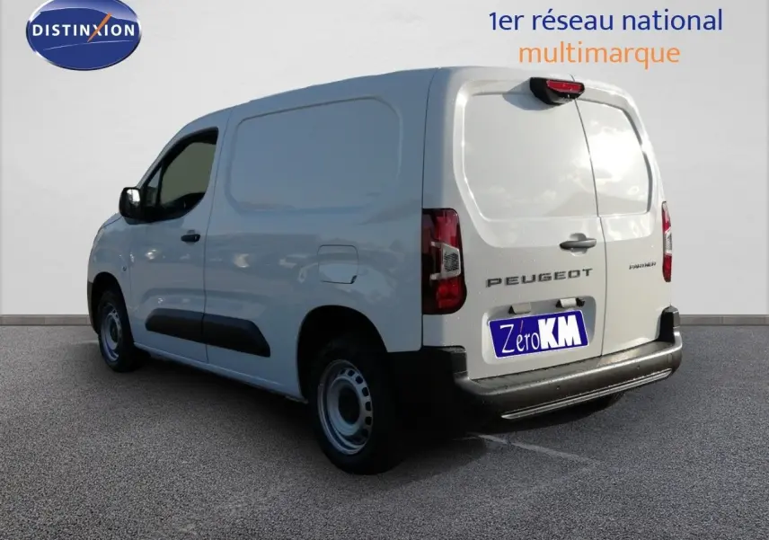 Vue 3/4 arrière droite d'un Peugeot Partner blanc Kaolin utilitaire avec porte latérale et hayon fermé.