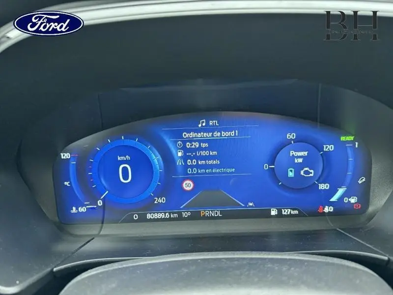 Tableau de bord numérique bleu du Ford Kuga 2022, affichant vitesse, puissance et informations de conduite.