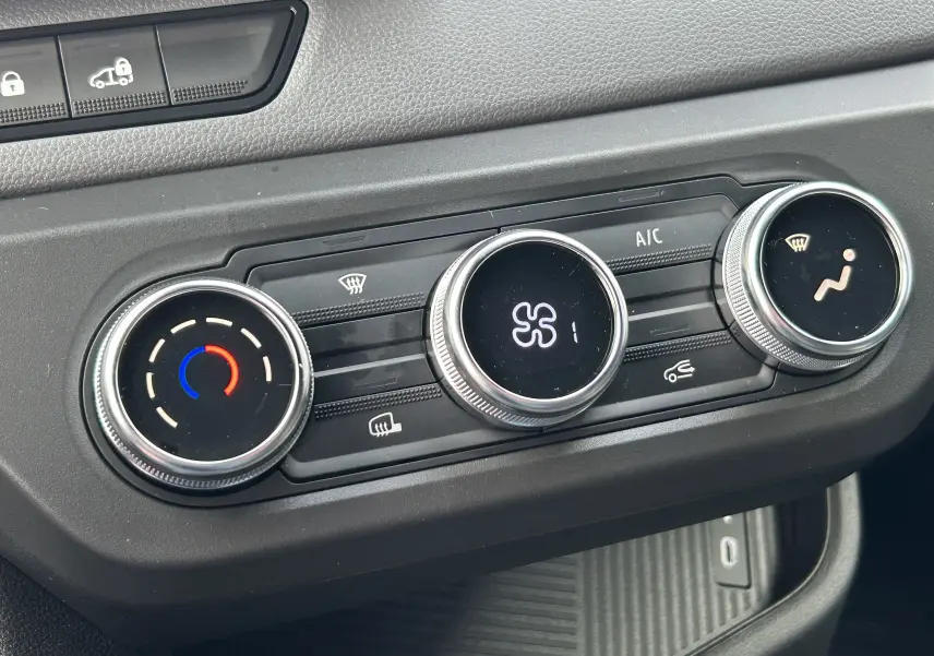 Gros plan sur les commandes de climatisation numériques du tableau de bord du Renault Master blanc, version 2026.