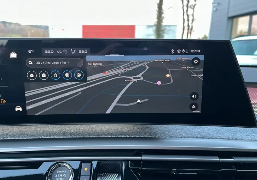 Écran tactile central du tableau de bord du Peugeot 5008 Hybrid 2025 affichant la navigation GPS en extérieur.