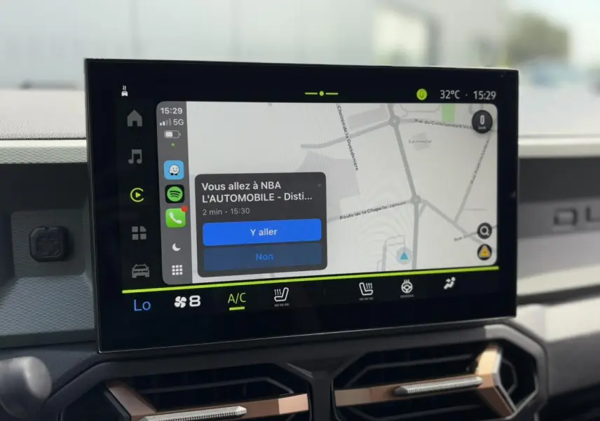 Écran tactile GPS 10 pouces du Dacia Duster 2025, avec interface navigation et commandes climatisation visibles