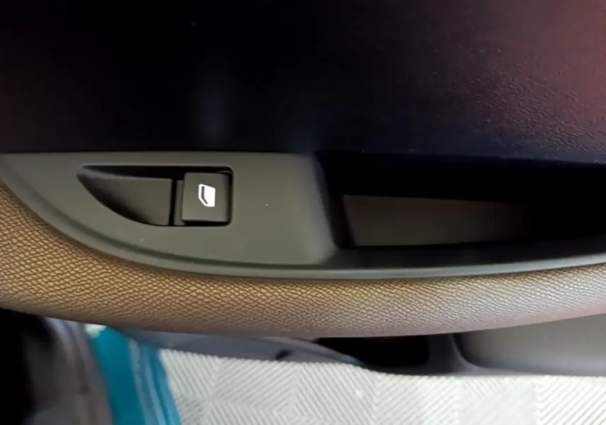 Bouton de commande de vitre électrique sur la porte intérieure côté conducteur d'une DS3 Crossback bleu 2020.