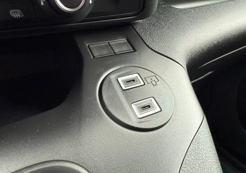 Gros plan sur les ports USB intégrés dans la console centrale noire du Peugeot Partner blanc Icy 2026.