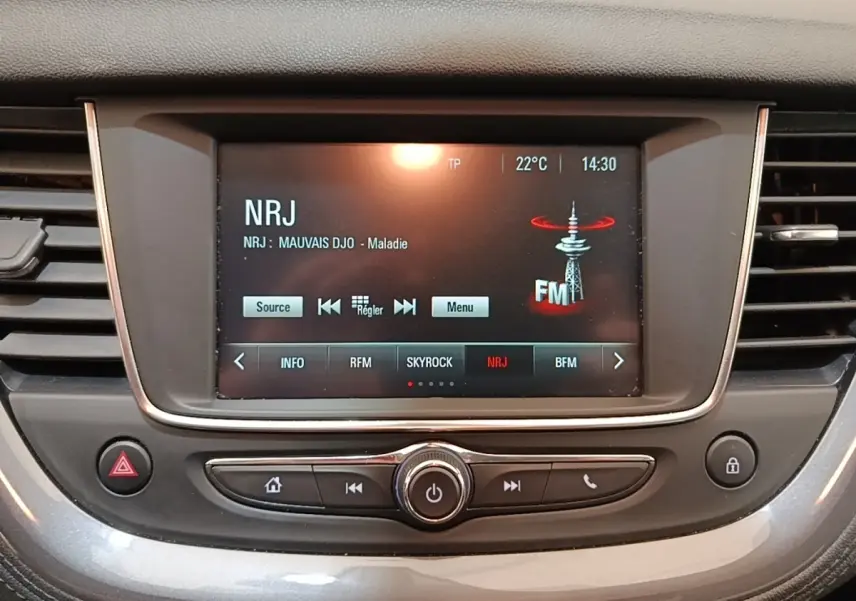 Écran tactile central de l’Opel Grandland X 1.5 Diesel 130 GS Line, affichant la radio NRJ en intérieur gris foncé.