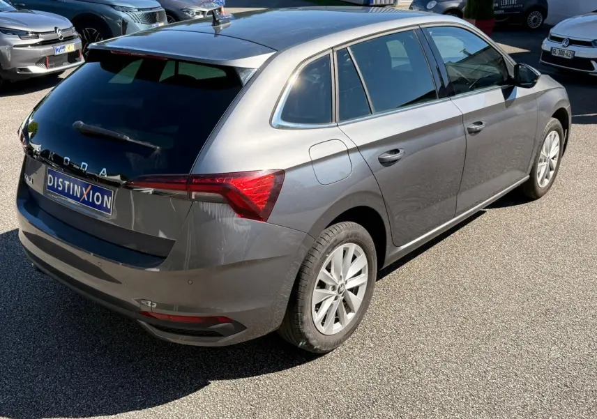 Vue 3/4 arrière droite d'une Skoda Scala gris graphite 2025 avec vitres teintées et jantes alliage.
