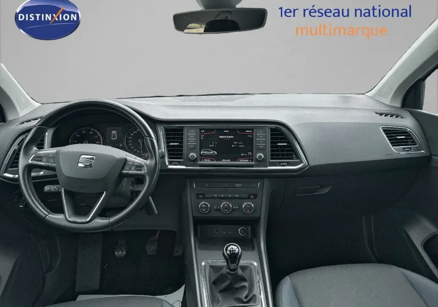 Vue intérieure avant du tableau de bord et volant noir d’un SEAT Ateca 2018 avec boîte manuelle et écran central.