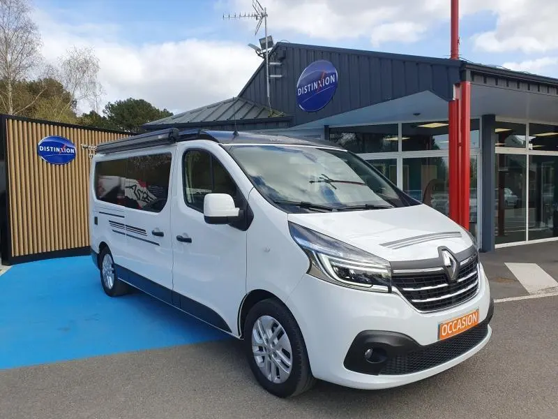 Renault Trafic Fourgon blanc Glacier vu en 3/4 avant droit, avec vitres teintées et jantes aluminium 17 pouces.