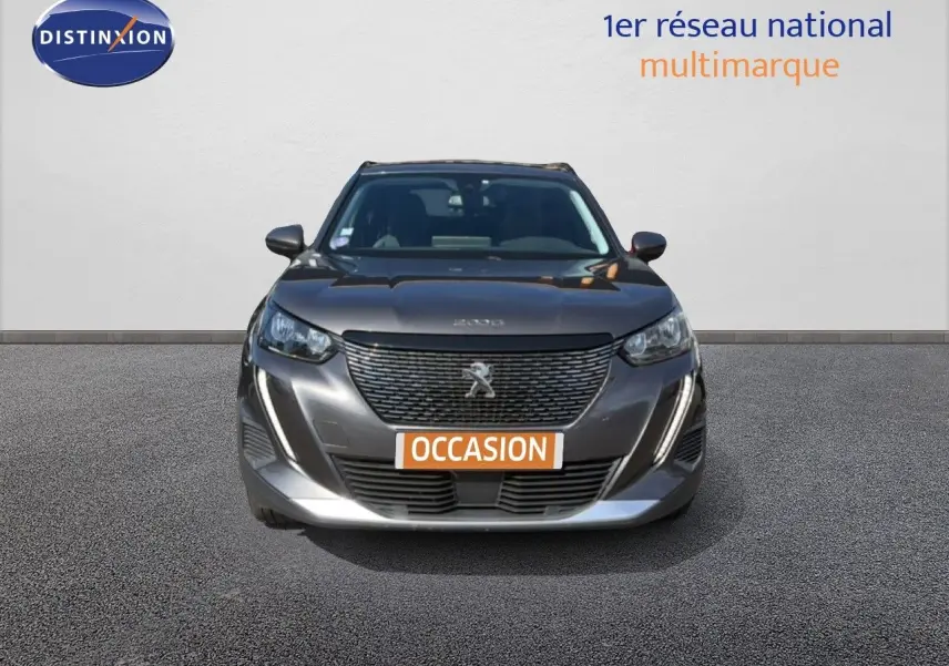 Vue frontale d'un Peugeot 2008 gris platinium avec calandre noire et plaque orange "OCCASION" visible.