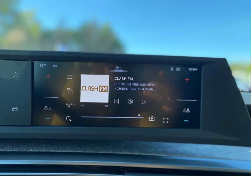 Écran tactile central du Peugeot 3008 noir 2025 affichant la radio Clash FM en extérieur lumineux.
