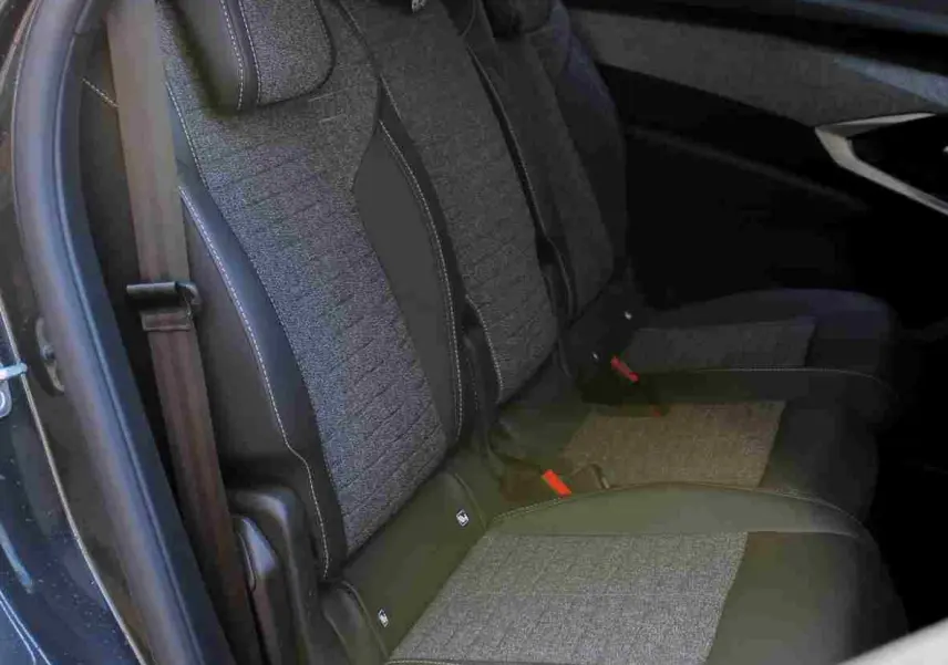 Vue latérale des sièges arrière gris noir en tissu et cuir du Peugeot 5008 III Hybrid 2025, avec ceinture de sécurité visible.