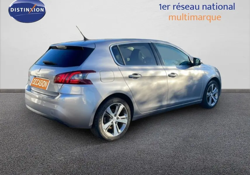 Peugeot 308 gris Artense métal vue 3/4 arrière côté droit, avec jantes alliage et vitres teintées.