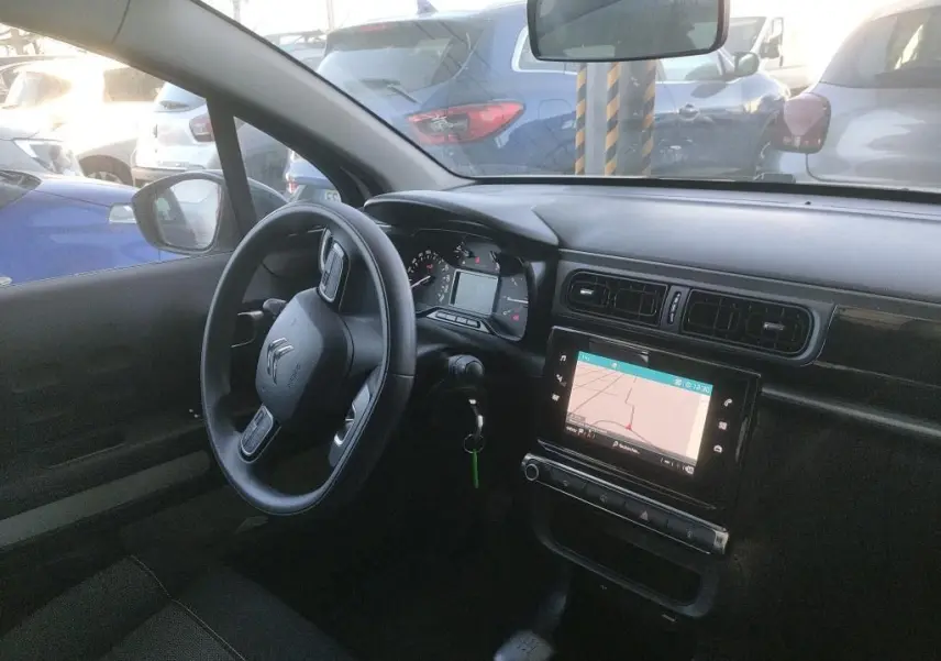 Vue intérieure côté conducteur de la Citroën C3 Société 2021 avec tableau de bord noir et écran tactile de navigation.