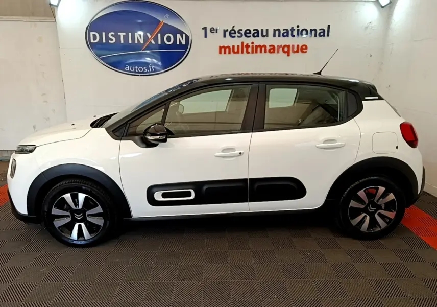 Profil droit d'une Citroën C3 blanche 2021 avec toit noir et protections latérales noires distinctives.