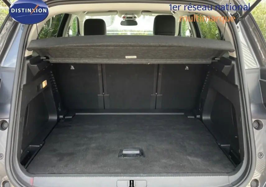 Coffre ouvert d’un Citroën C5 Aircross Hybrid gris platinium, vue arrière montrant l’espace de chargement vide.